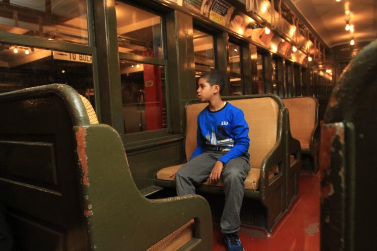 Ian Aquino, 9, at the Transit Museum in Brooklyn, where he participates in the museum's Subway Sleuth program which lets kids with autism learn about trains and buses in a safe way. Brooklyn, New York, Friday, November 11, 2016. (Jesse Ward for New York Daily News)